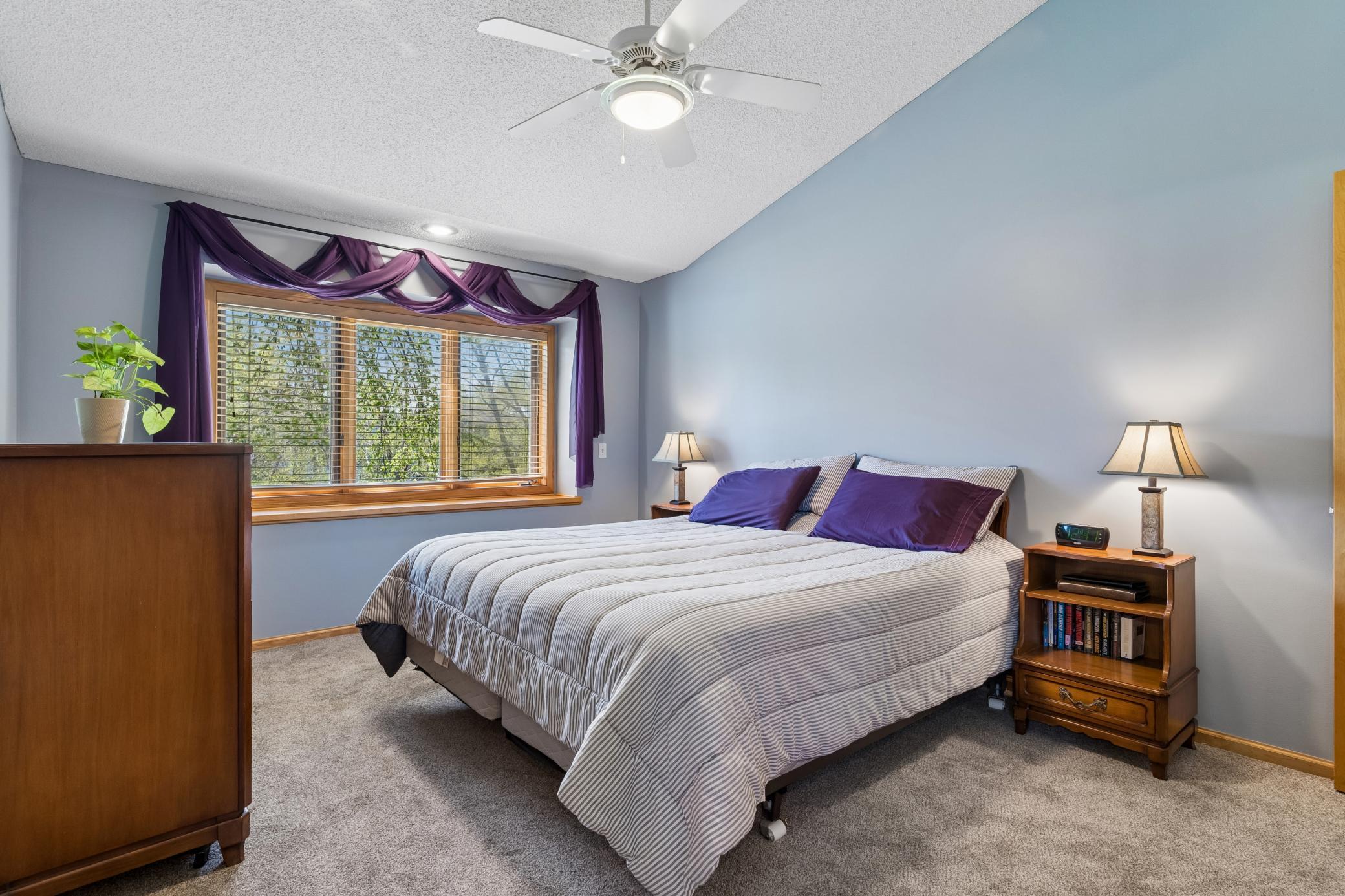 Primary Bedroom with Vaulted Celings and new carpet.