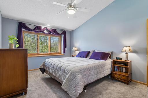 Primary Bedroom with Vaulted Celings and new carpet.