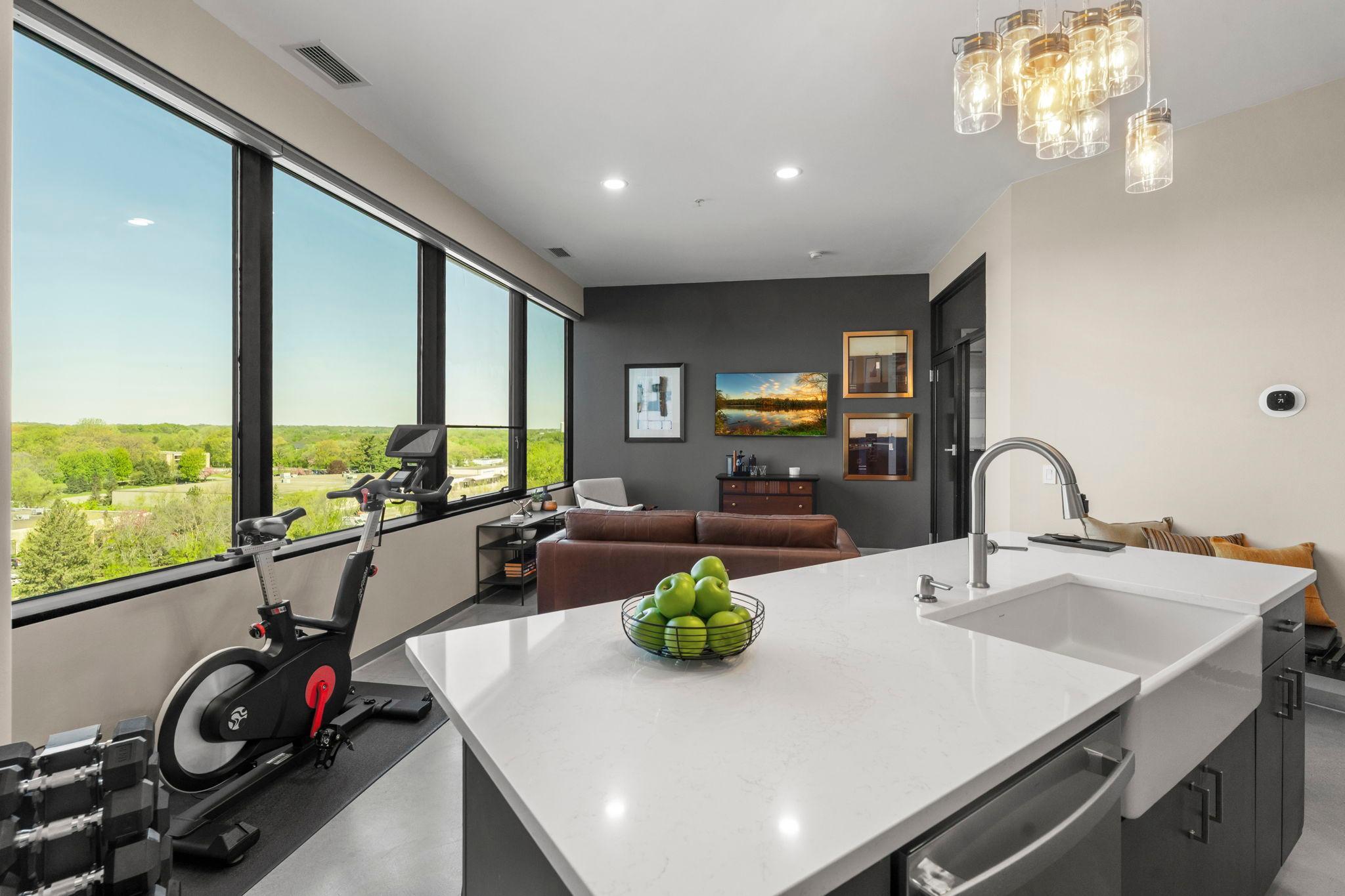 Open flow between the kitchen and living spaces, all accentuated by large picture windows with Hunter Douglas PowerView electric blinds