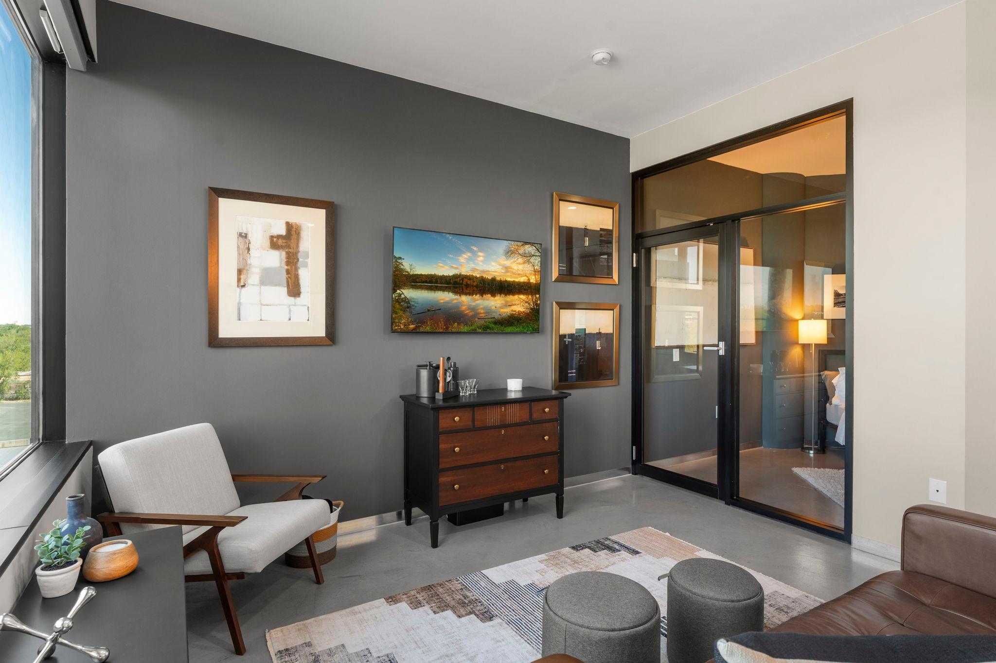 Chic glass doors allow the bedroom to share in the beautiful views