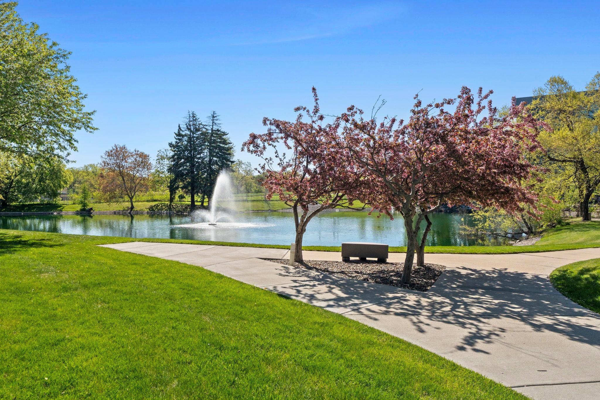 Lush, well-maintained grounds showcase a serene pond and fountain
