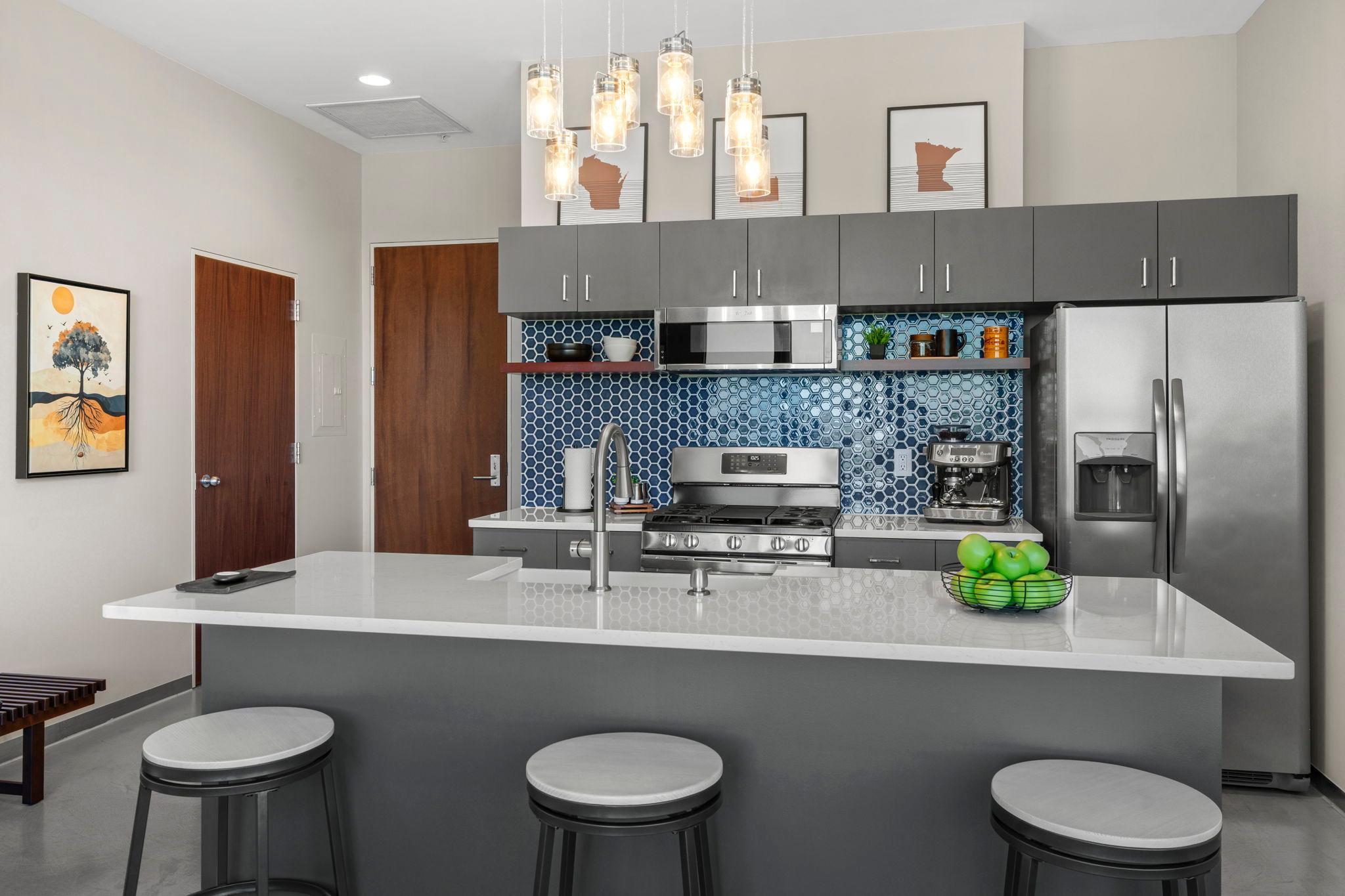 Enjoy quartz countertops, a farmhouse sink, stainless steel appliances, and a center island with additional seating