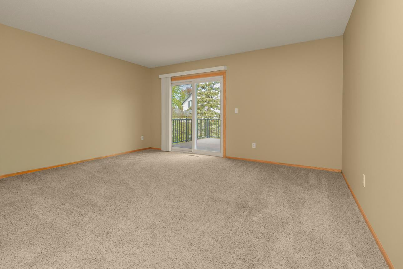 Living Room with Patio Door to Deck Overlooking Backyard