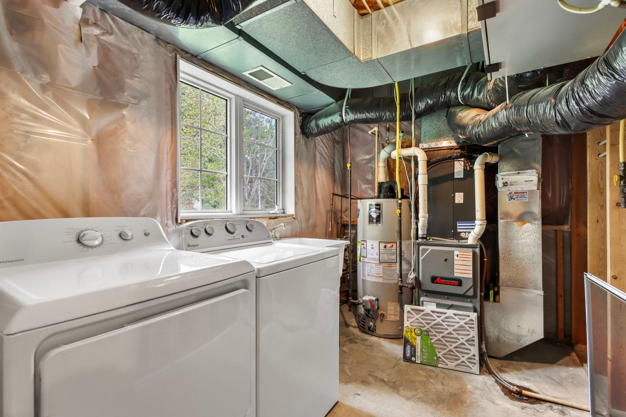 Lower level unfinished laundry and mechanical room overlooking backyard