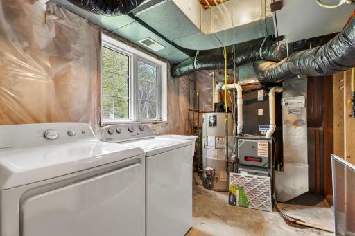 Lower level unfinished laundry and mechanical room overlooking backyard