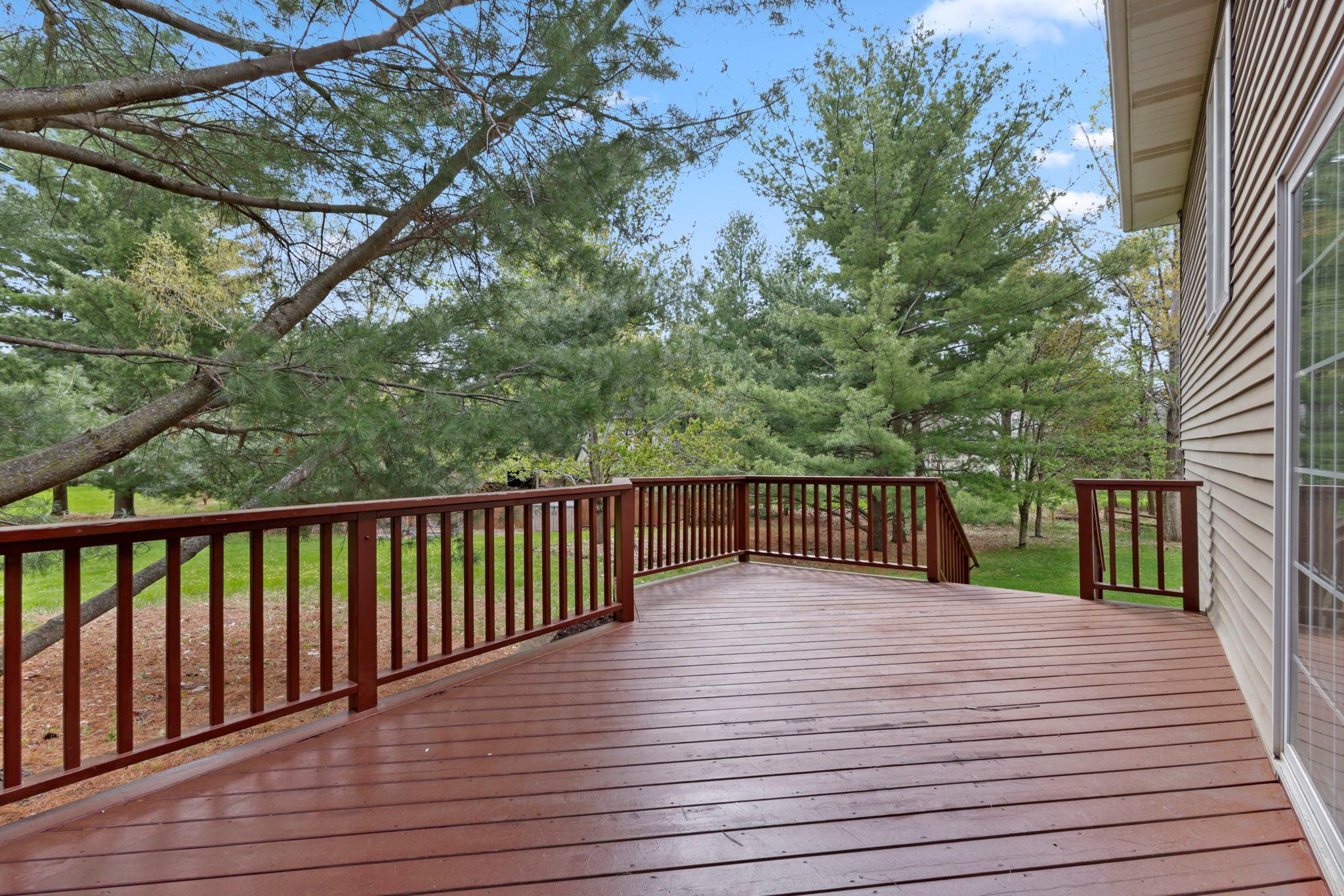 Recently stained deck on side yard leading into backyard