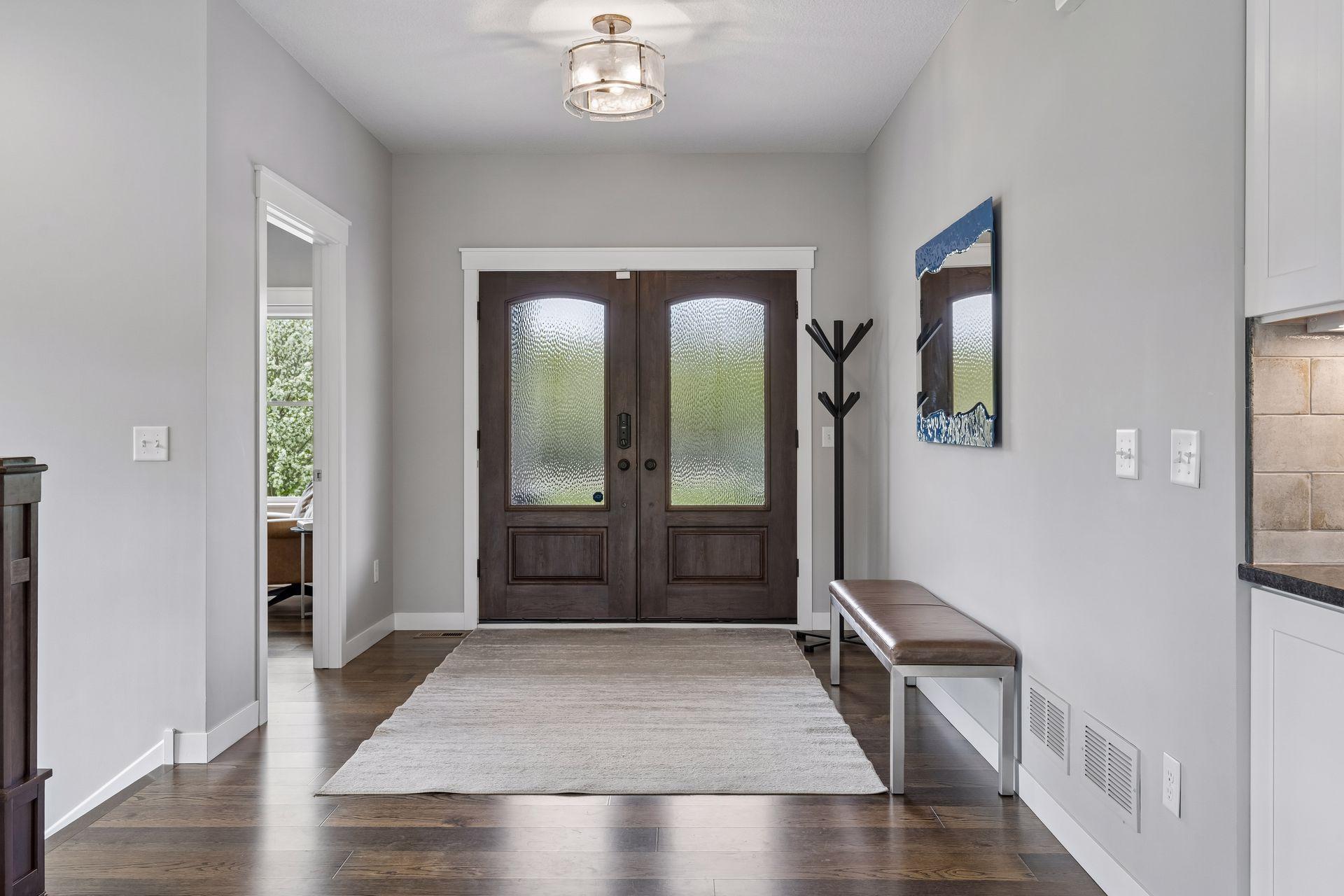Spacious front entry with engineered wood floors, custom wood doors, and open-concept design creating a bright and welcoming first impression. Thoughtfully designed luxury home with quality craftsmanship throughout.