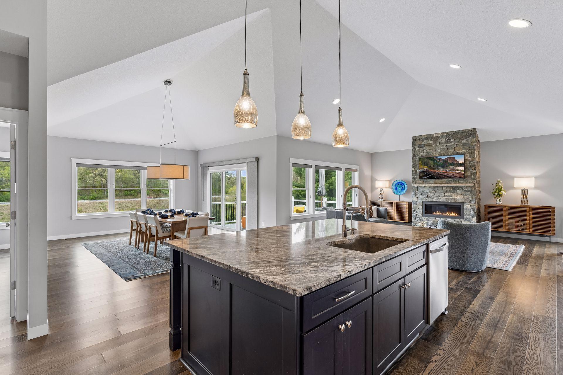 Luxury kitchen with expansive island, vaulted ceilings, walk-in pantry area, and open dining space overlooking the backyard. High-end finishes combined with convenience and functionality.