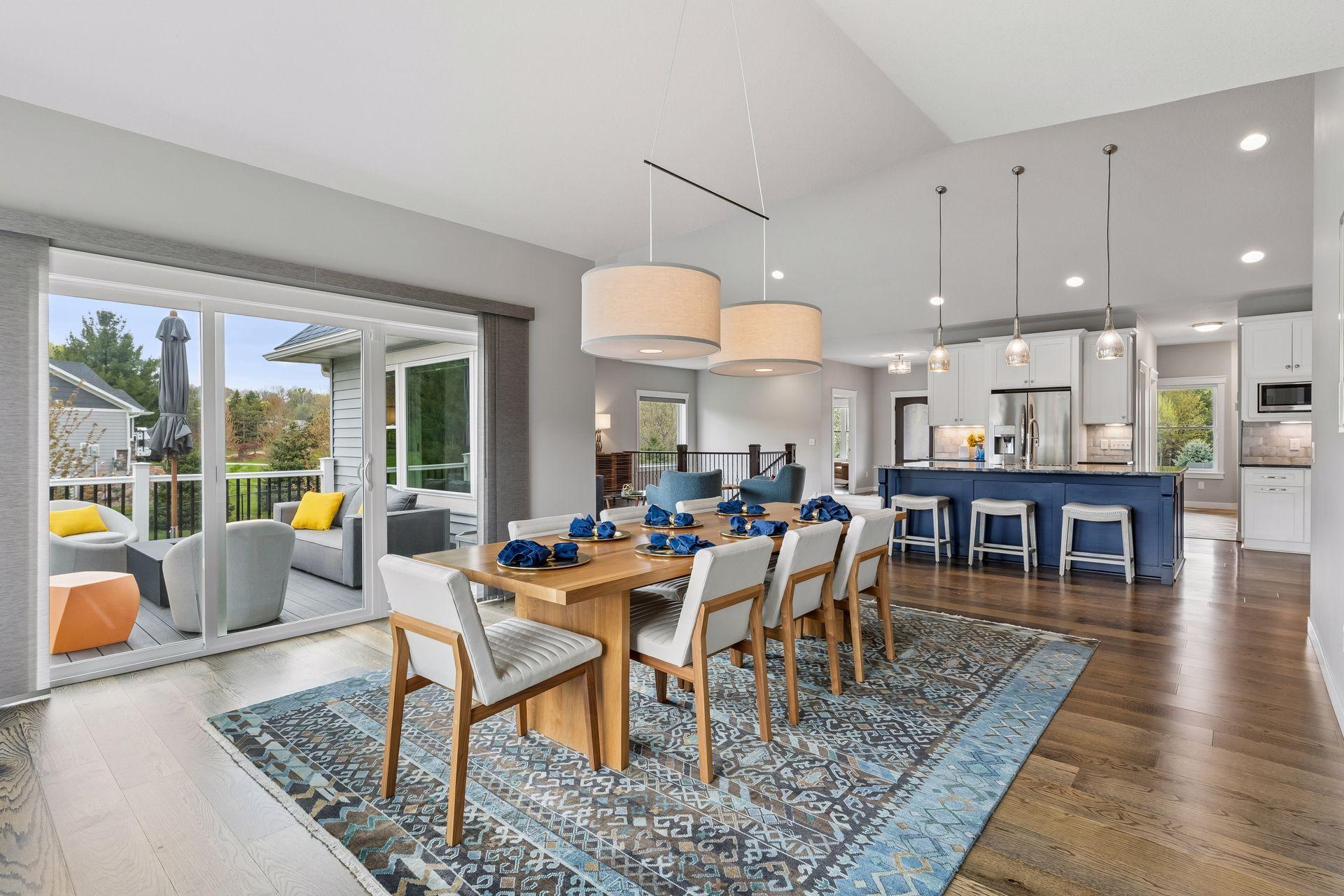 Open dining area flowing into the gourmet kitchen and living room with engineered wood floors, modern lighting and spacious layout designed for comfortable luxury living.