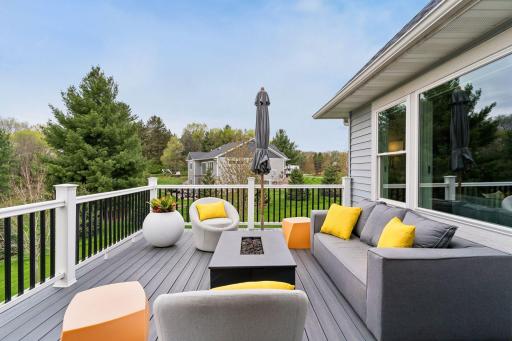 Maintenance-free deck with peaceful backyard views and space for outdoor dining, relaxing, and entertaining. Enjoy privacy, nature and a country-living feel in the city.