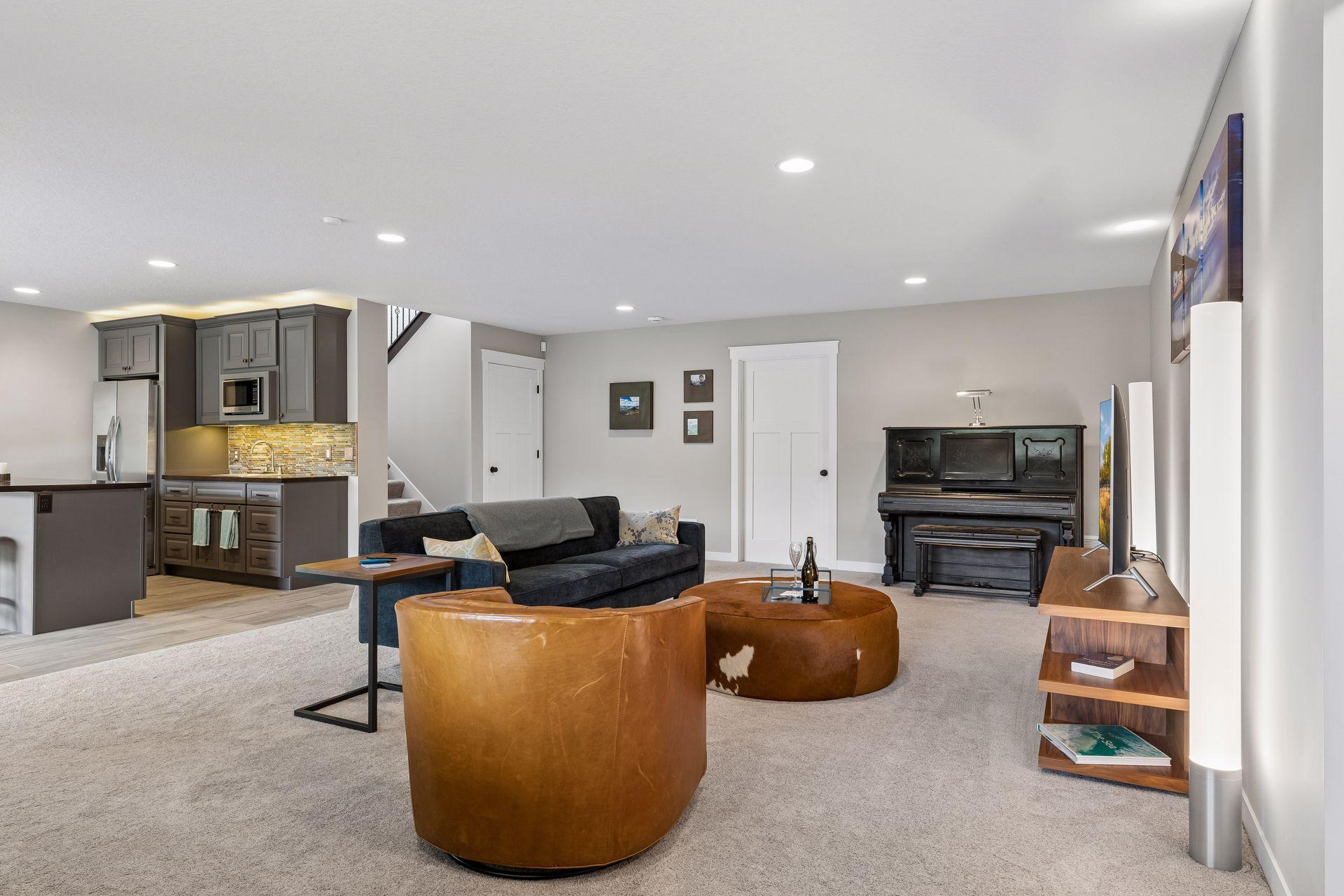 Bright and spacious walkout lower level featuring large family room, cozy fireplace, wet bar area, and flexible recreation space. Ideal for entertaining and multi-generational living.