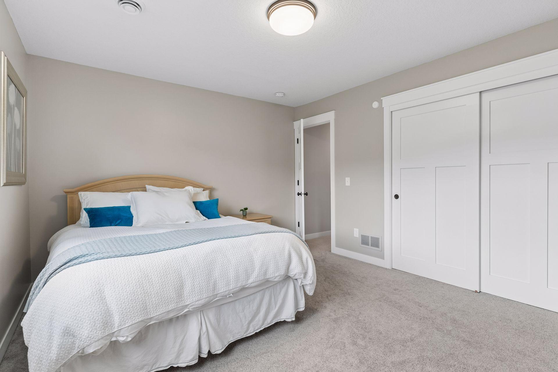 Lower-level 2nd bedroom featuring neutral finishes, oversized closet, and flexible layout. Great for guests, multi-generational living, or private retreat space.