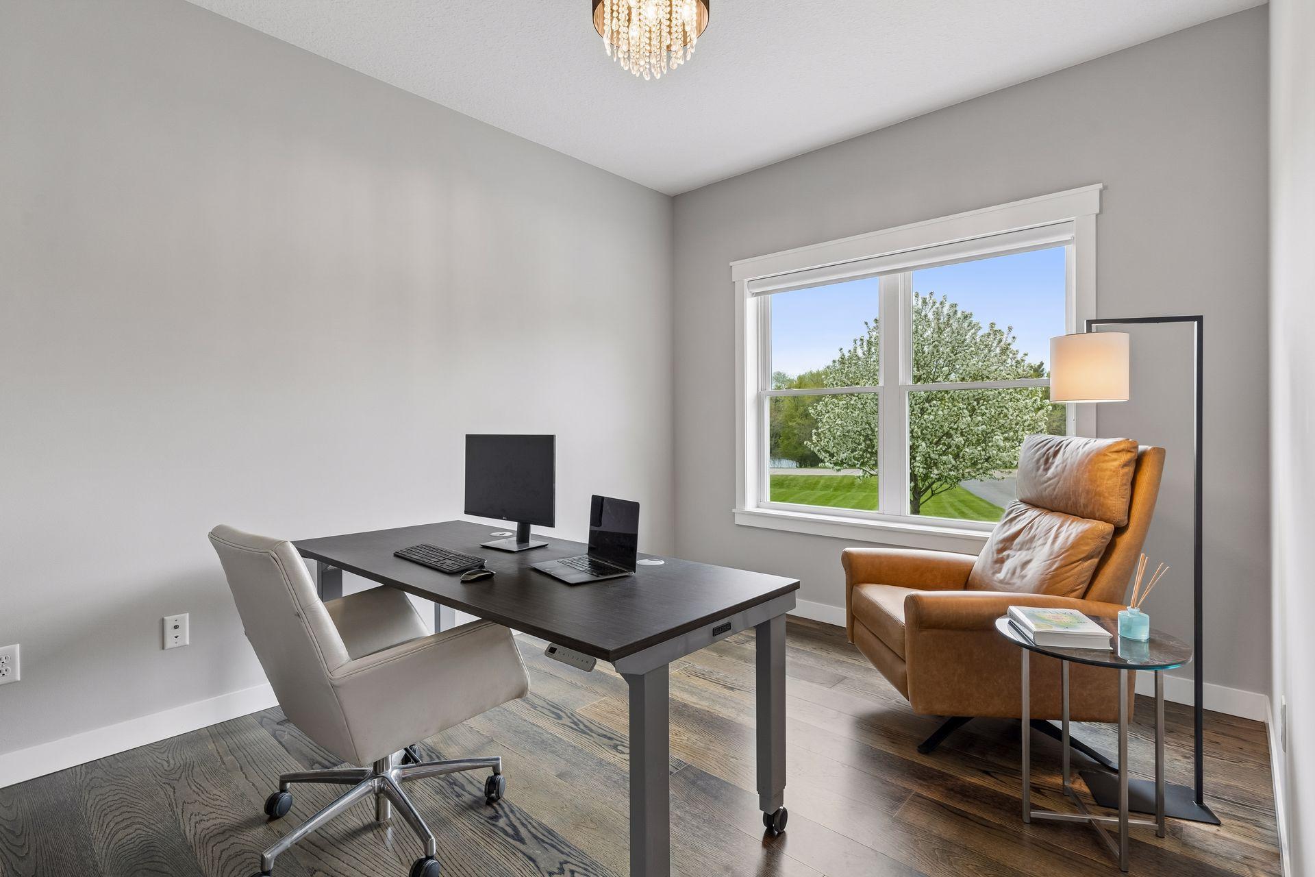 Spacious main-level office with engineered wood floors, large window, and flexible work-from-home setup. Ideal private office, study or future 4th bedroom with space to add a closet.