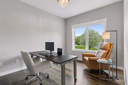 Spacious main-level office with engineered wood floors, large window, and flexible work-from-home setup. Ideal private office, study or future 4th bedroom with space to add a closet.