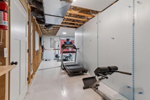 Bonus lower-level exercise and storage space offering flexibility for a home gym, workshop, hobby area, or additional storage. Durable flooring and generous layout provide endless possibilities.