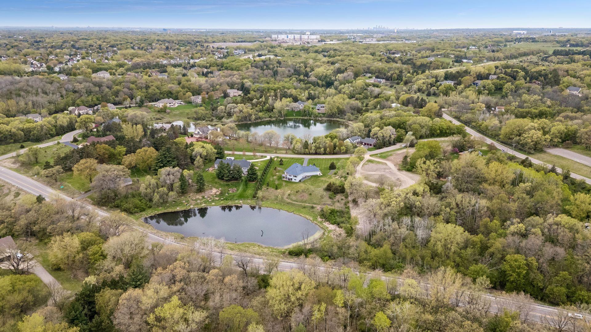 Panoramic aerial view highlighting the home’s convenient location with quick access to the Twin Cities, major highways, shopping, dining, and MSP International Airport, while still offering peaceful privacy and stunning natural surroundings.