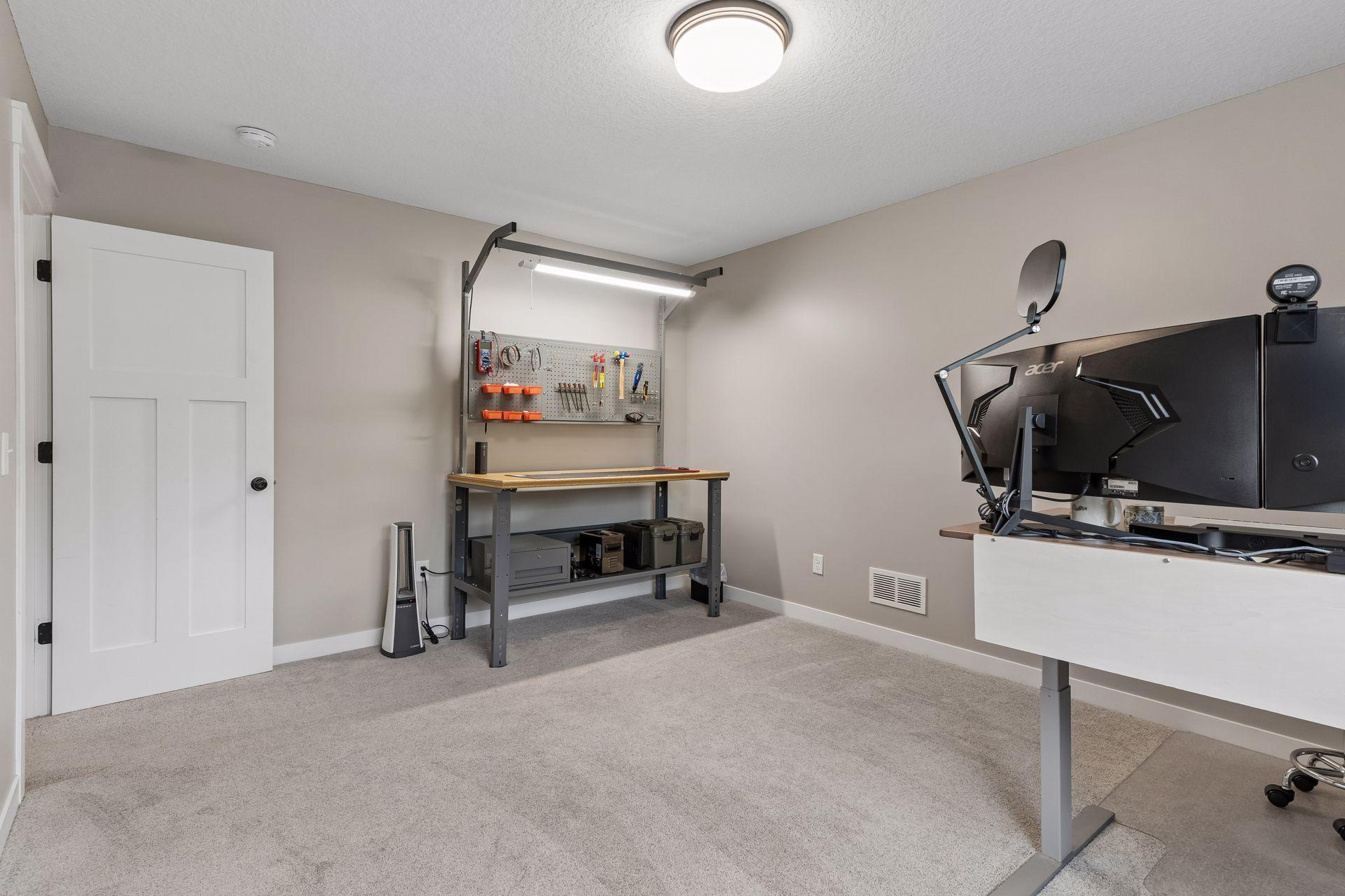 Another view of the spacious 3rd lower-level bedroom featuring plush carpeting, large closet and flexible layout. Bright and comfortable space for guests, family or everyday living.