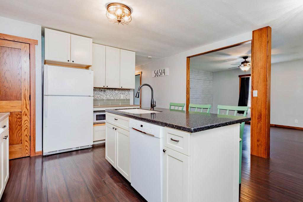 Corian countertops, breakfast bar island, Shaker-style cabinets