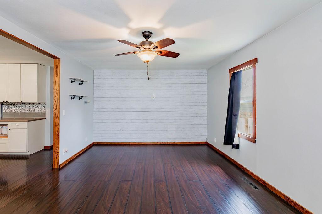 Cozy, bright Living Room with slat accent wall & ceiling fan