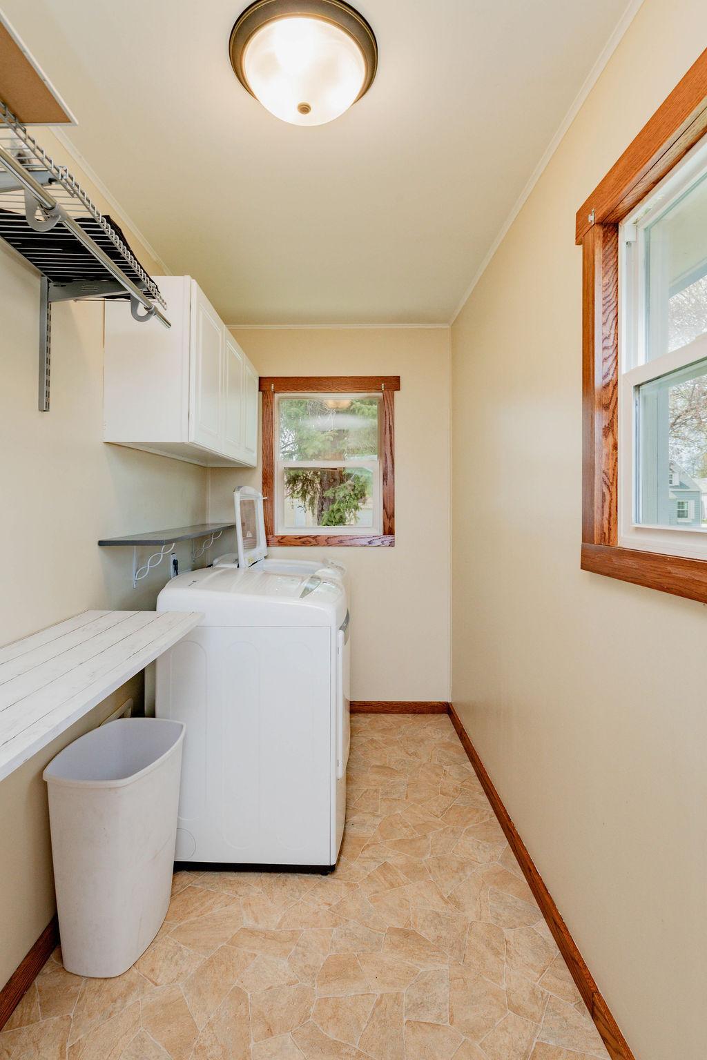 Laundry Room offers windows, folding counter, cabinets