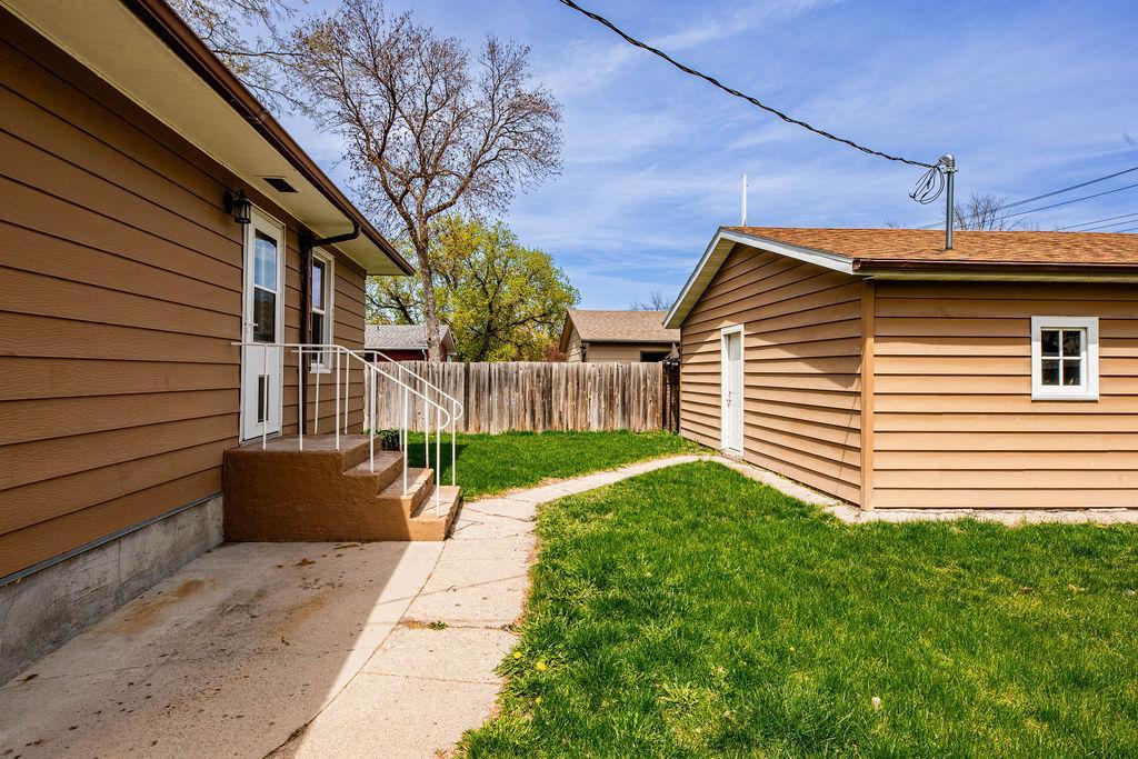 Back entrance, patio, walk to garage, fenced yard