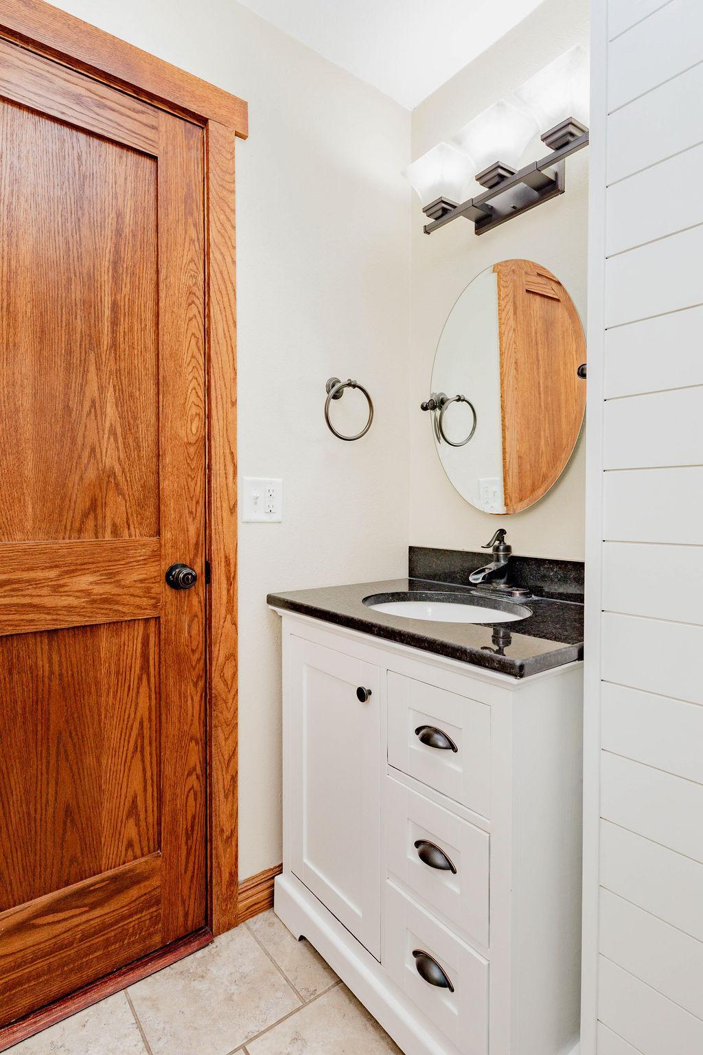 Shiplap accent wall, Stone countertop vanity