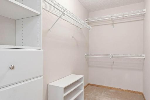Primary suite walk in closet with built in organizers