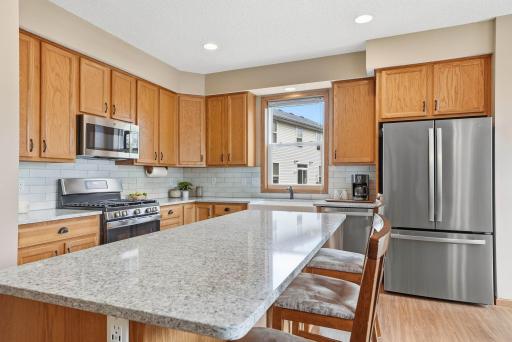 Kitchen recently renovated in 2025 with Quartz Countertops, GE Appliances, Tile Backsplash, and Kohler Farm Sink