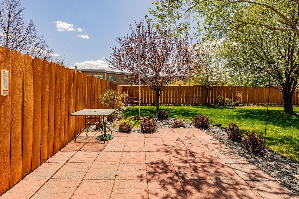 Privacy fence, paver patio, treed backyard
