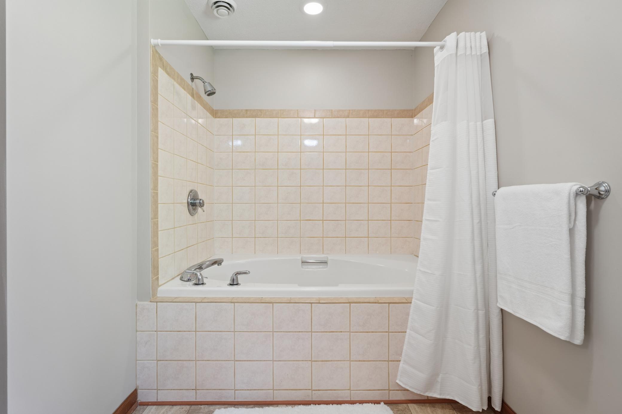 The full bath offers a large soaking tub and shower