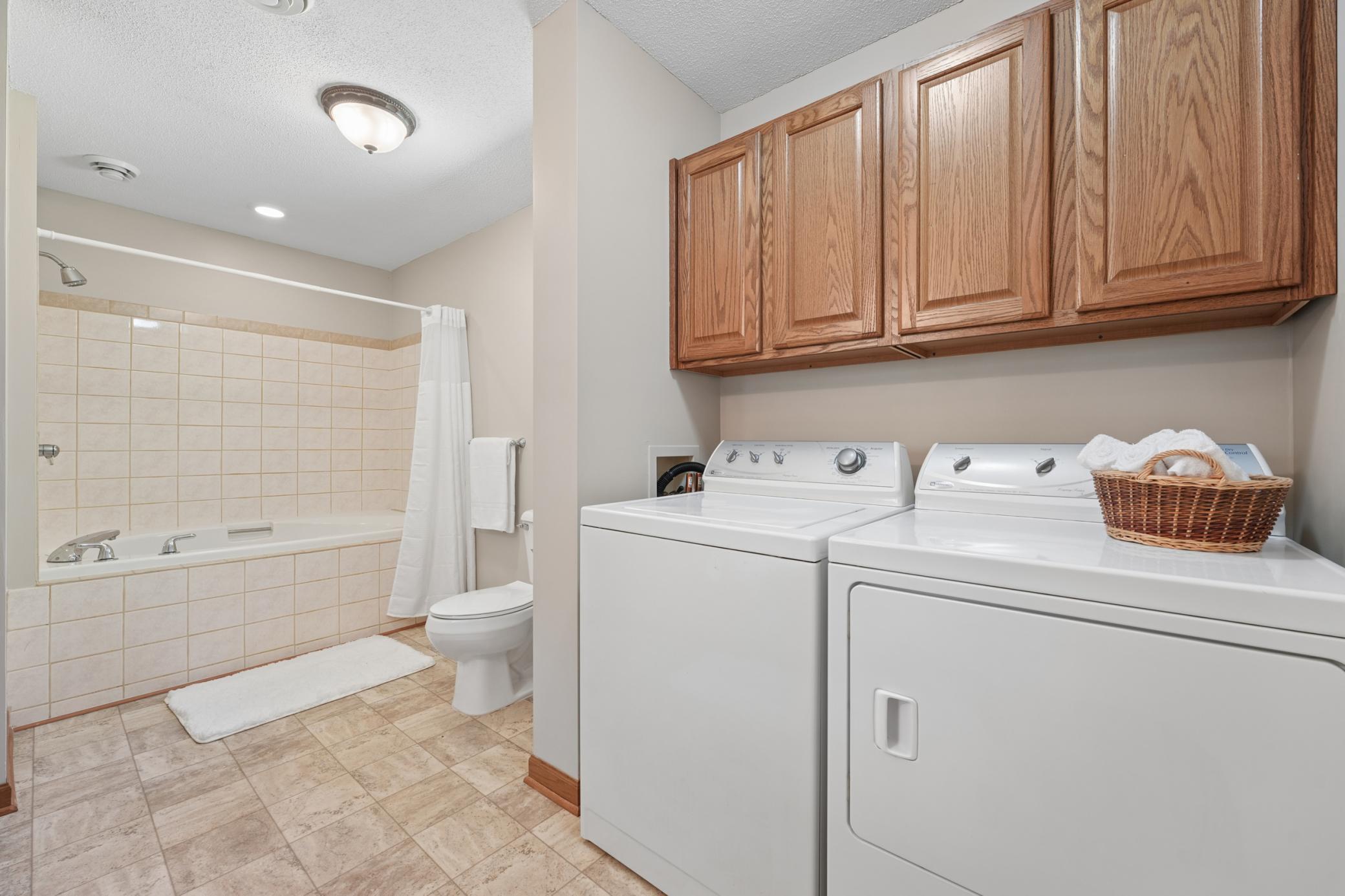 The bathroom also has a full size washer & dryer with overhead cabinetry