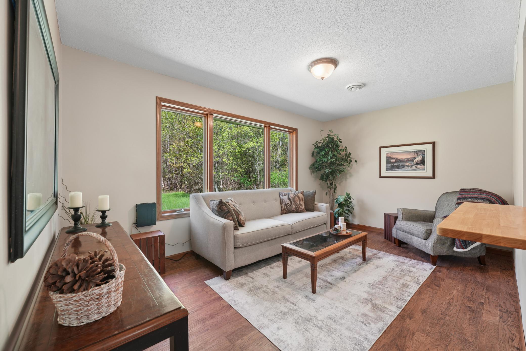 Lovely living room space with large window of the backyard