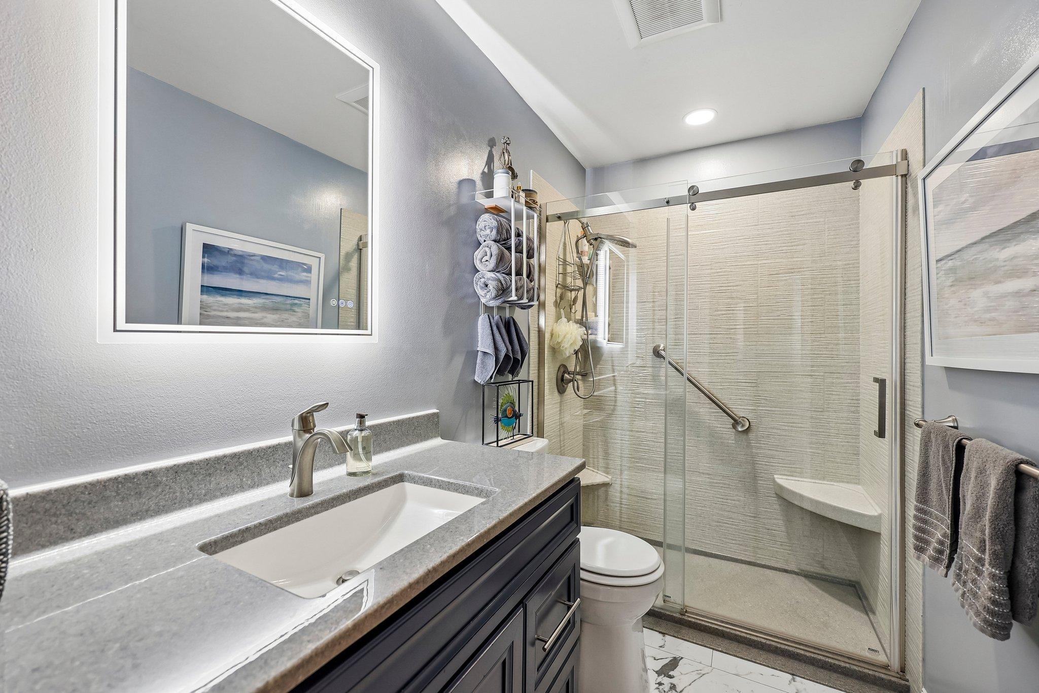 Recently remodeled 3/4 bath with backlit mirror