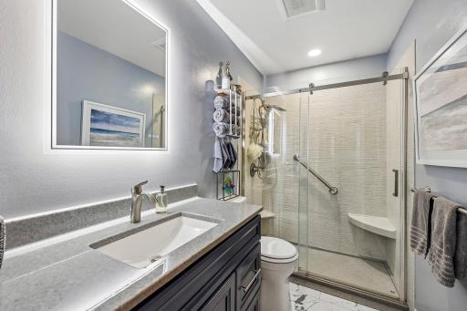 Recently remodeled 3/4 bath with backlit mirror
