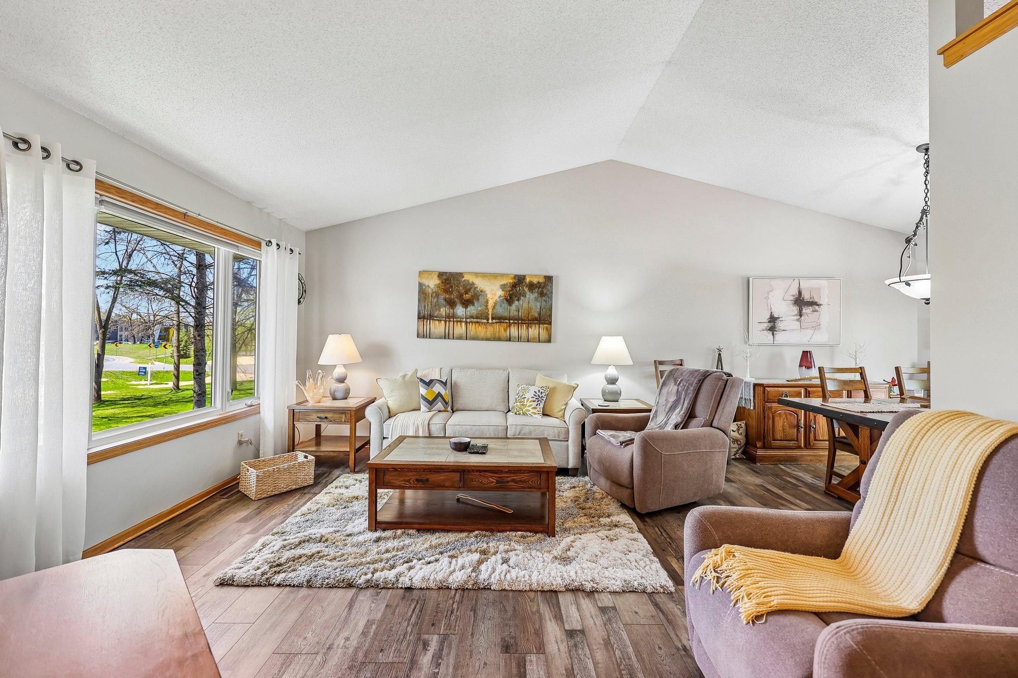 Bright and sunny living room - vaulted ceilings & newer LVP flooring!