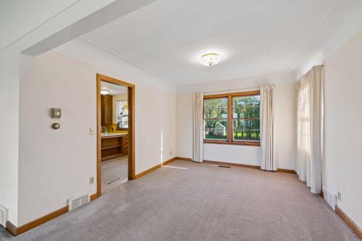 The formal dining room, filled with natural light from dual windows, offers the perfect setting for hosting family gatherings and entertaining friends with ease.