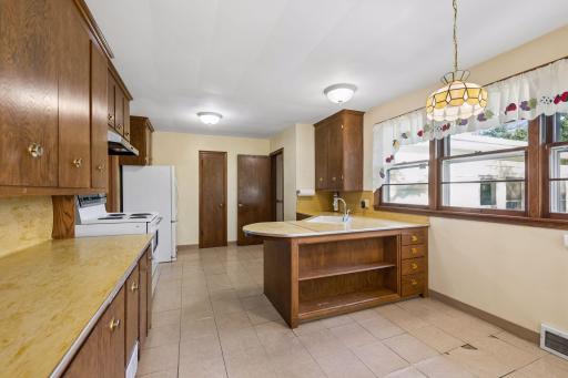 Transition into the kitchen and informal dining area, offering the perfect space for casual meals.