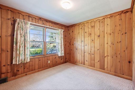 First main floor bedroom with charming knotty wood.