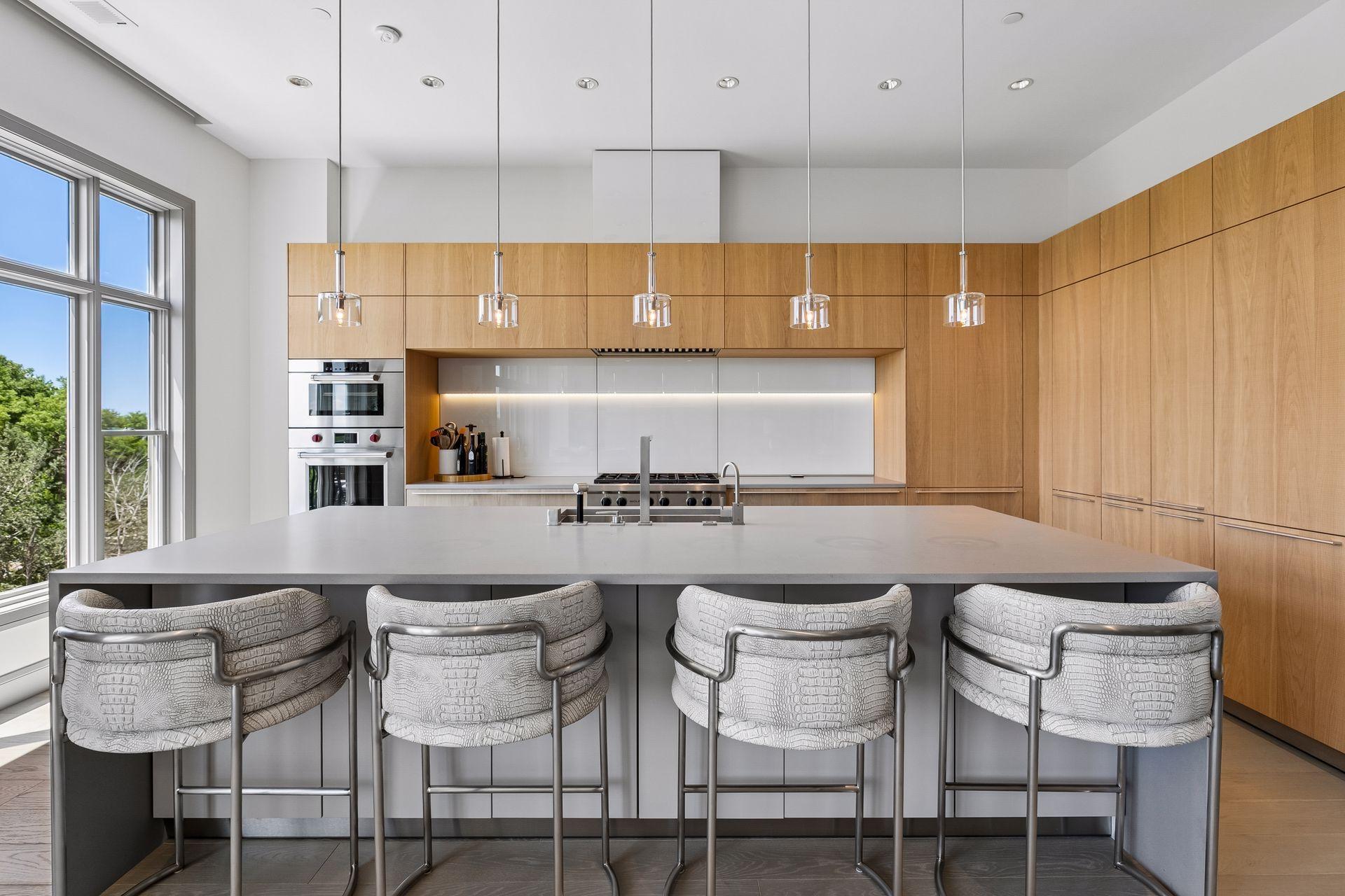 Designer kitchen featuring rift-cut cabinetry, center island with room for seating, and high end appliances