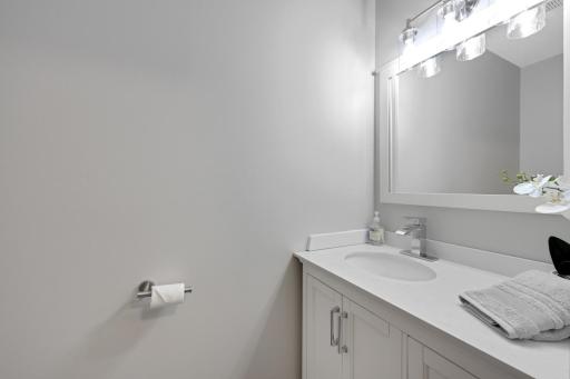 Main level 1/2 bath, newer vanity, toilet, and fixtures.