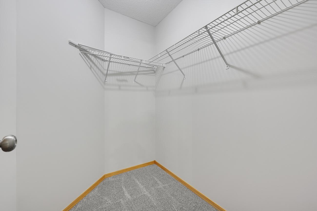 Primary bedroom walk-in closet