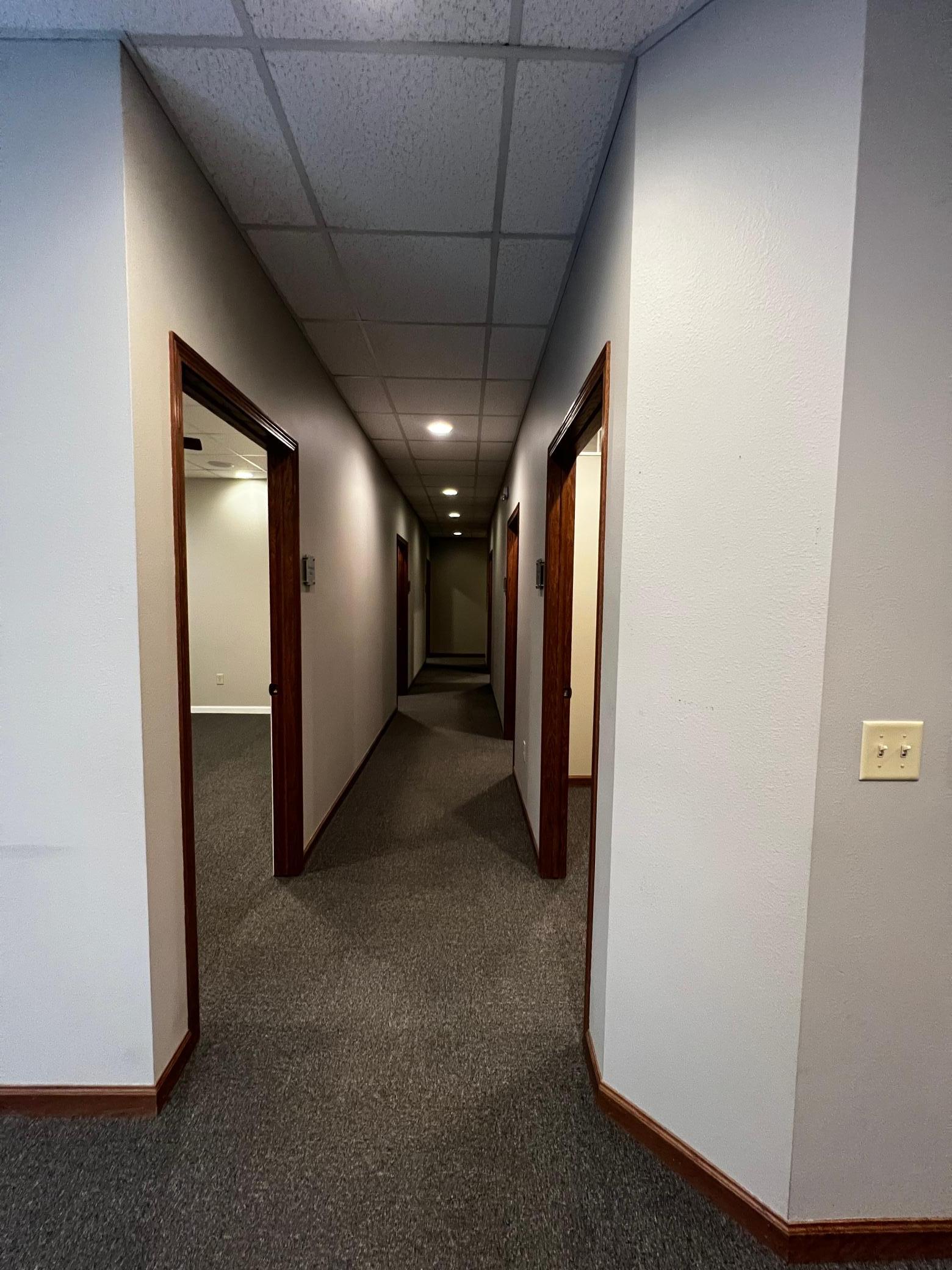 Hallway to all offices/meeting rooms, utility room and restroom.