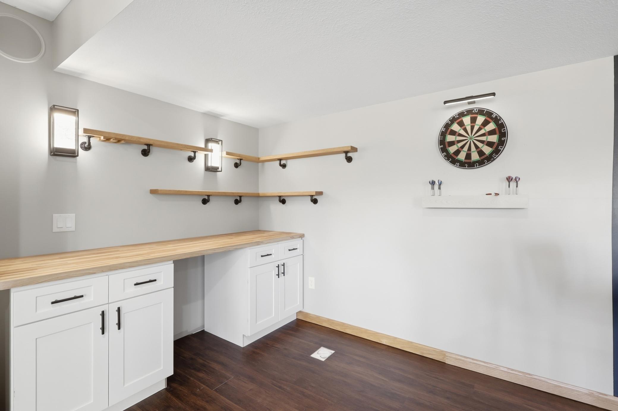 Lower level entertainment area featuring a built in dry bar, perfect for hosting guests or relaxing nights at home.