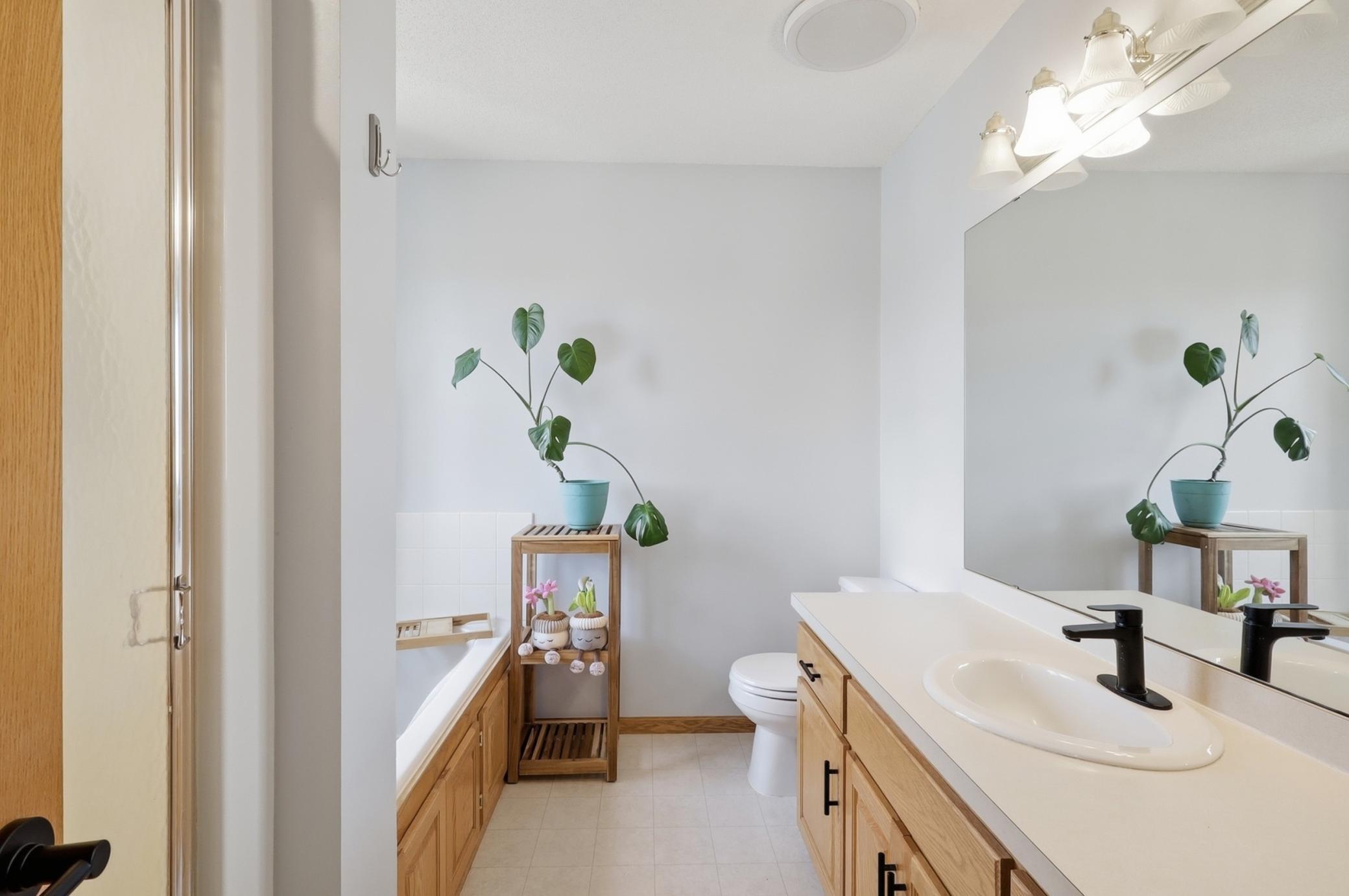 private ensuite featuring a separate tub and shower.