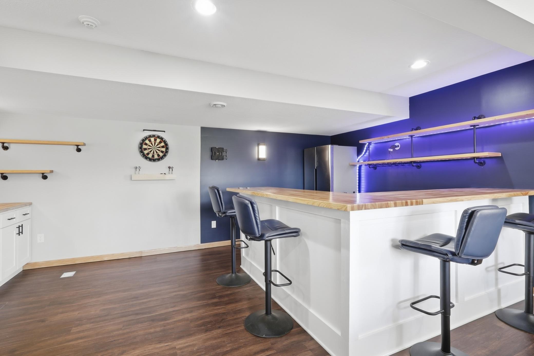 Lower level entertainment area featuring a built in dry bar, perfect for hosting guests or relaxing nights at home.