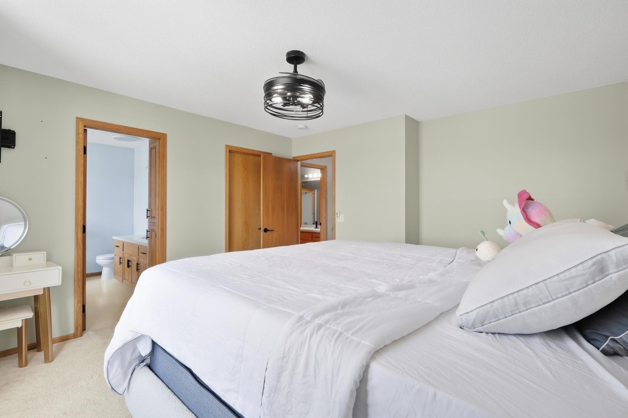 Spacious upper level primary bedroom overlooking the backyard with a private ensuite featuring a separate tub and shower.