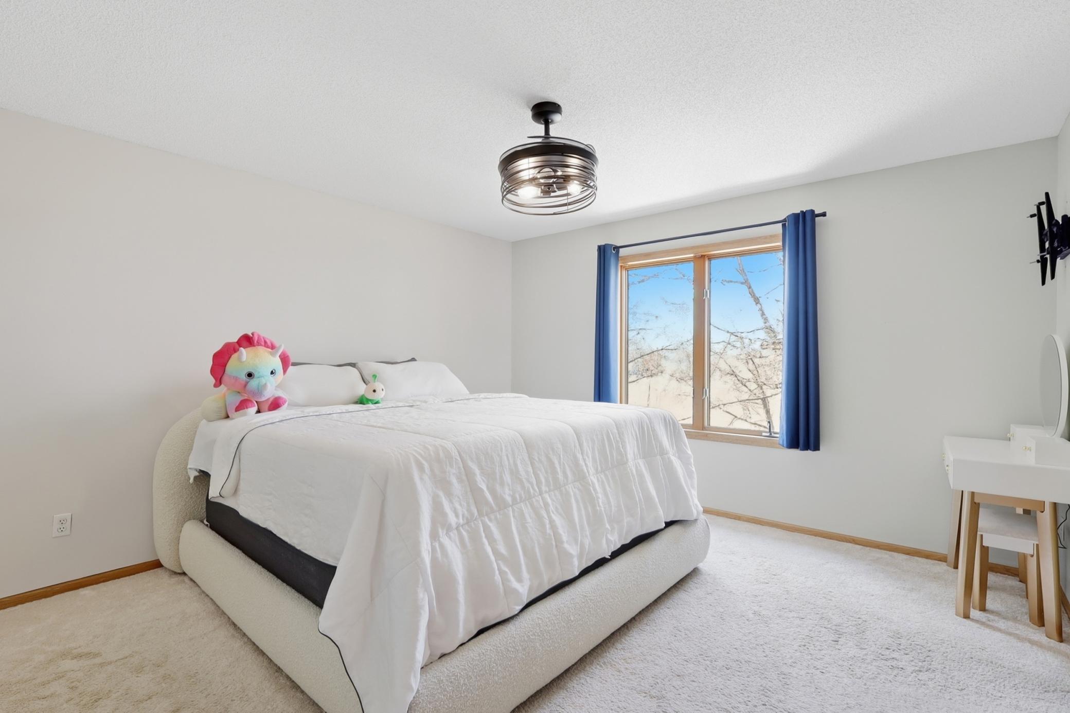Spacious upper level primary bedroom overlooking the backyard with a private ensuite featuring a separate tub and shower.