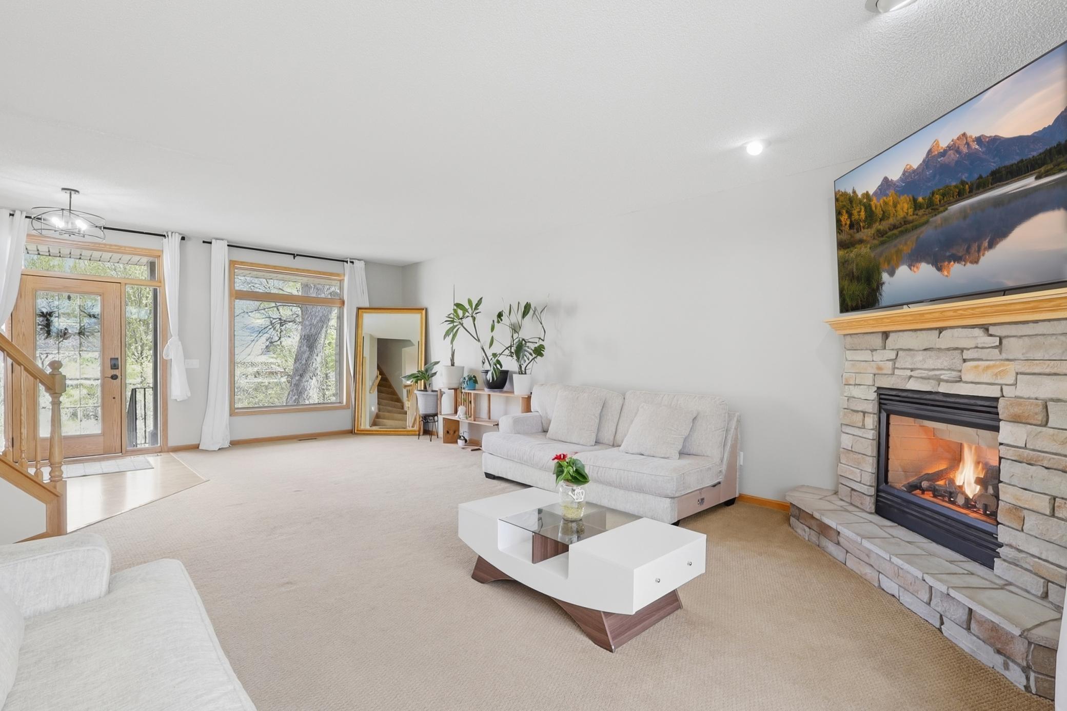 Sun filled living room with large windows overlooking peaceful wildlife views and bringing in tons of natural light throughout the day.