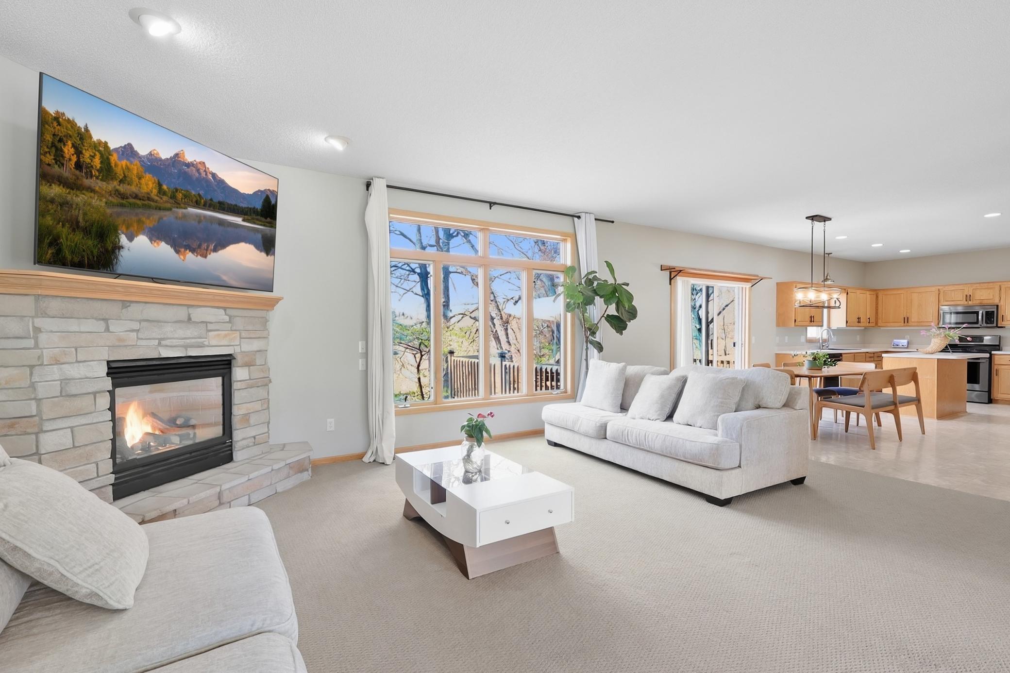 Sun filled living room with large windows overlooking peaceful wildlife views and bringing in tons of natural light throughout the day.