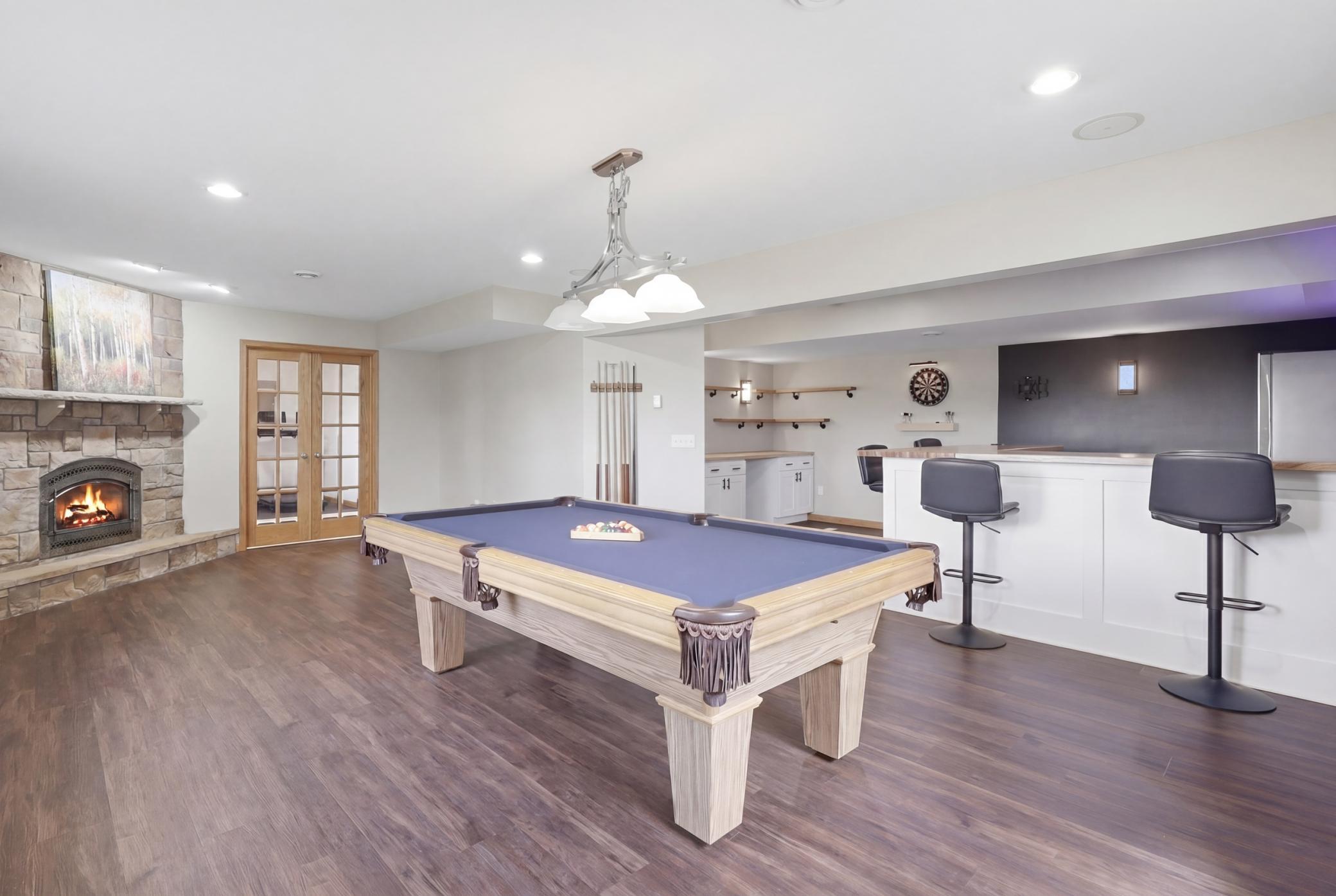 Lower level entertainment area featuring a built in dry bar, perfect for hosting guests or relaxing nights at home.